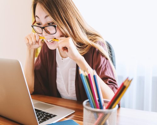 A person stretching gently near their office desk