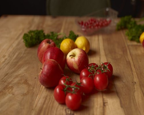 Fresh local Polish apples and vegetables on a wooden table